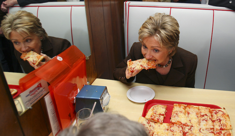 Democratic presidential hopeful, Sen. Hillary Rodham Clinton, D-N.Y., eats pizza during a lunch stop at Revello's Cafe Pizzeria, while campaigning in Old Forge, Penn., Monday, March 10, 2008. (AP Photo/Carolyn Kaster)